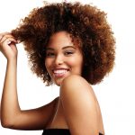 woman with natural makeup afro hair is laughing